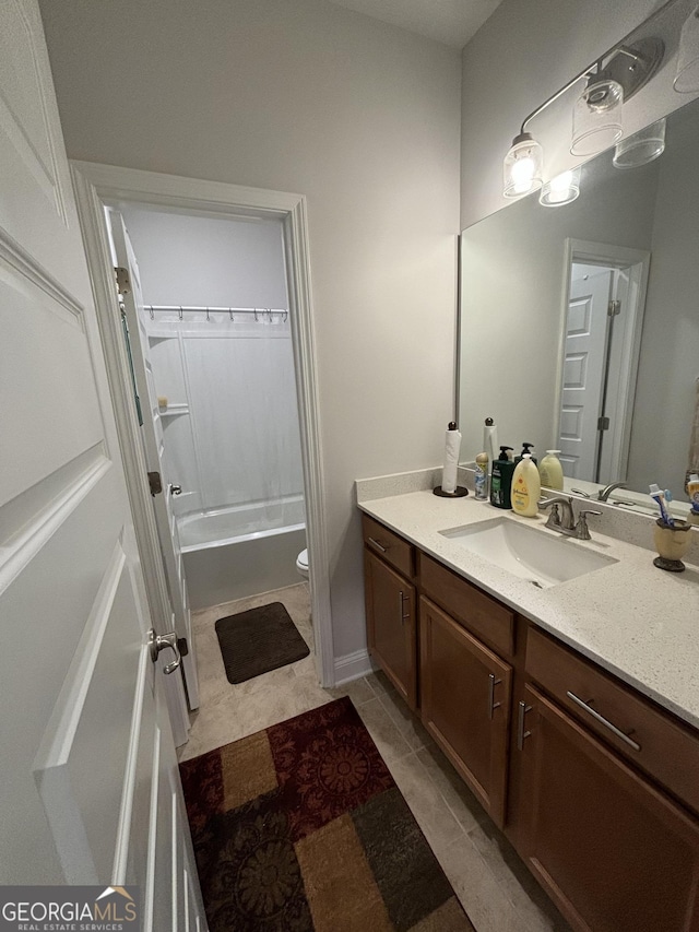 full bathroom featuring tile patterned floors, vanity, toilet, and  shower combination