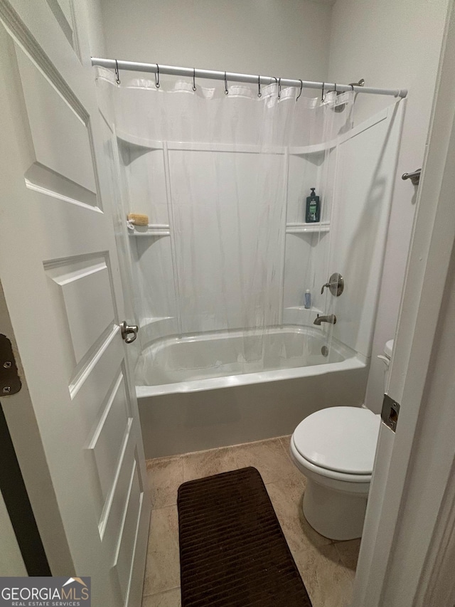 bathroom with shower / tub combo and toilet