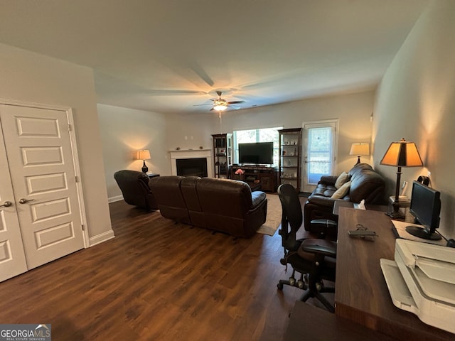 living room with dark hardwood / wood-style flooring and ceiling fan