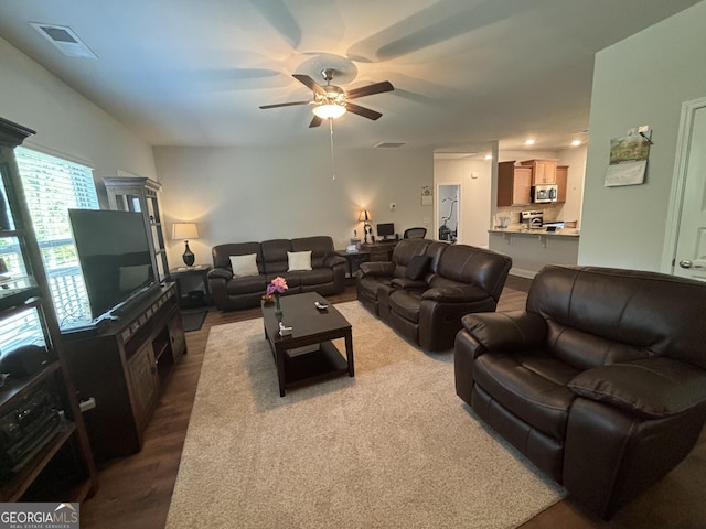 living room with hardwood / wood-style flooring and ceiling fan