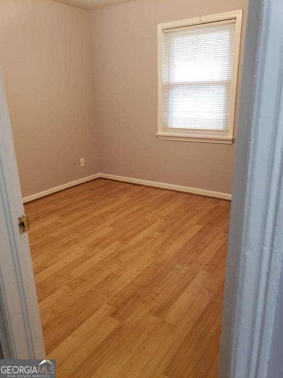 spare room featuring light hardwood / wood-style flooring