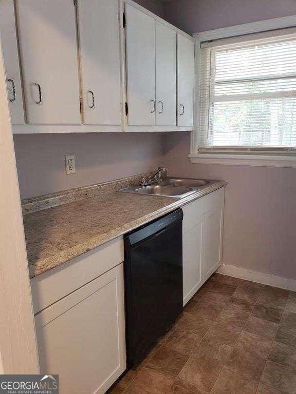 kitchen featuring white cabinetry, sink, and dishwasher