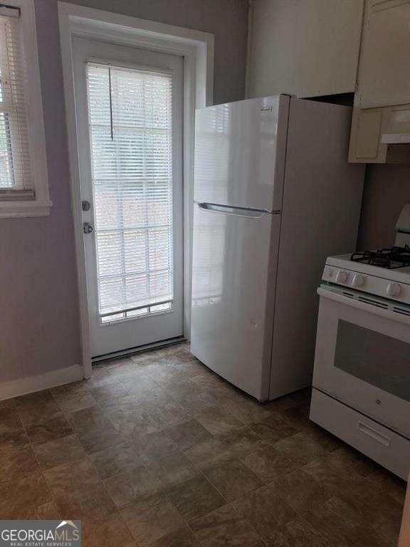 kitchen with white cabinetry and white appliances