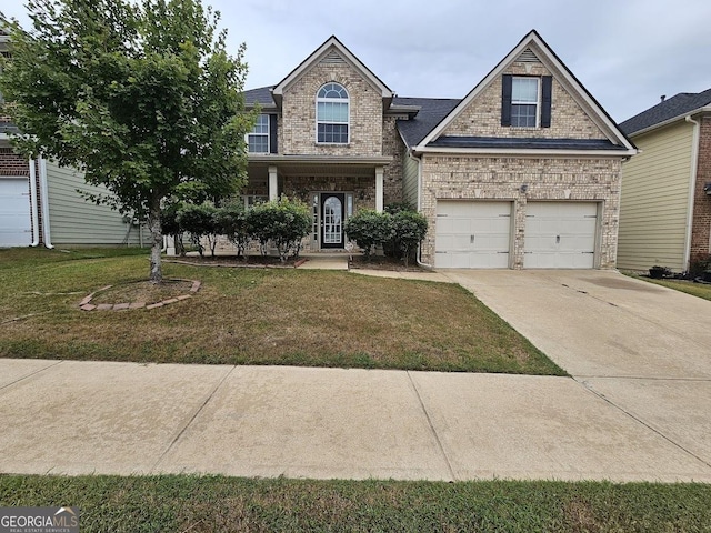 view of front of property featuring a garage and a front yard