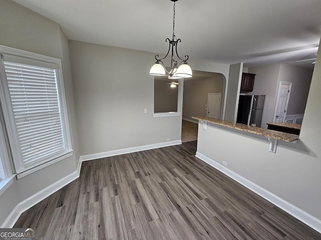 interior space featuring a notable chandelier and dark wood-type flooring