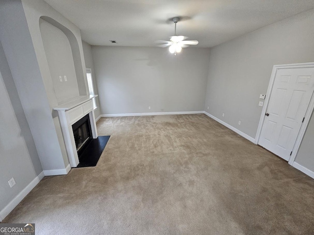 unfurnished living room featuring light colored carpet and ceiling fan