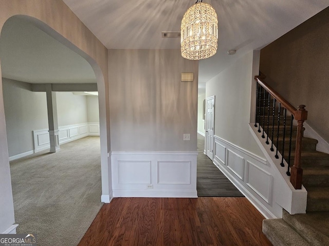 interior space featuring dark hardwood / wood-style floors and a chandelier