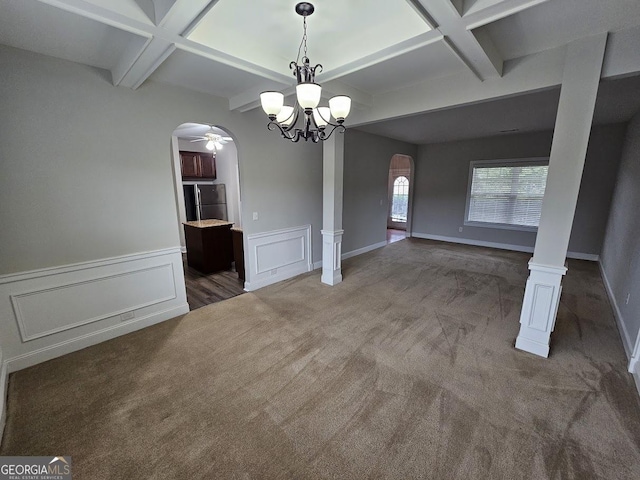 unfurnished dining area featuring beamed ceiling, coffered ceiling, decorative columns, and dark colored carpet