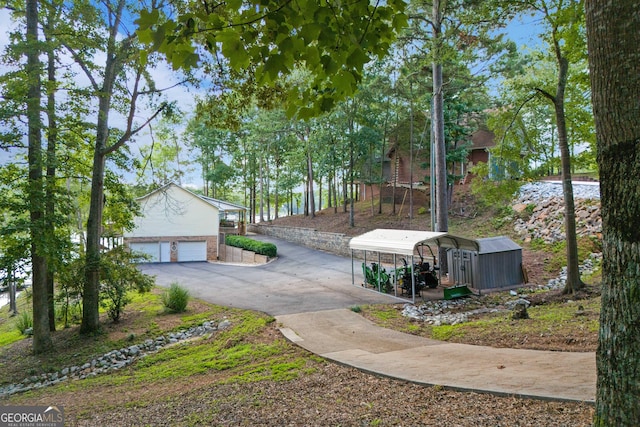 373 Pineywoods Dr, Wedowee, AL 36278 - view of yard featuring a detached garage and driveway