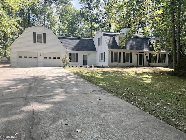 cape cod-style house with a garage and a front yard