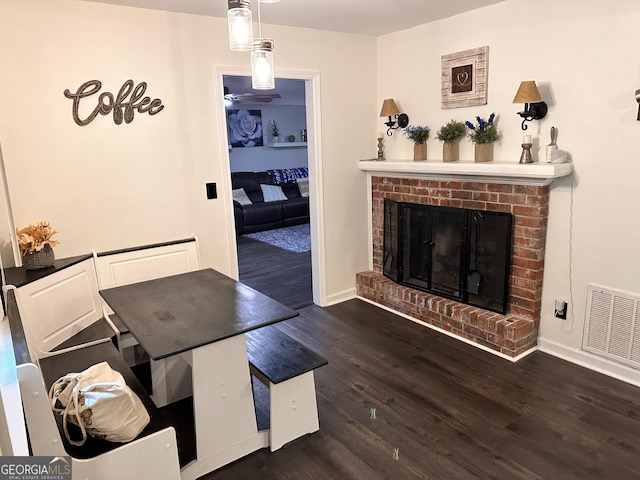 interior space featuring a fireplace and dark wood-type flooring