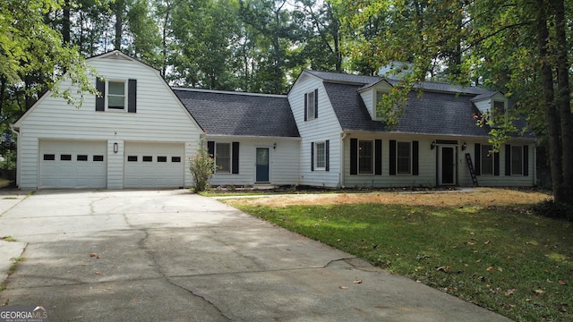 cape cod house with a garage and a front lawn