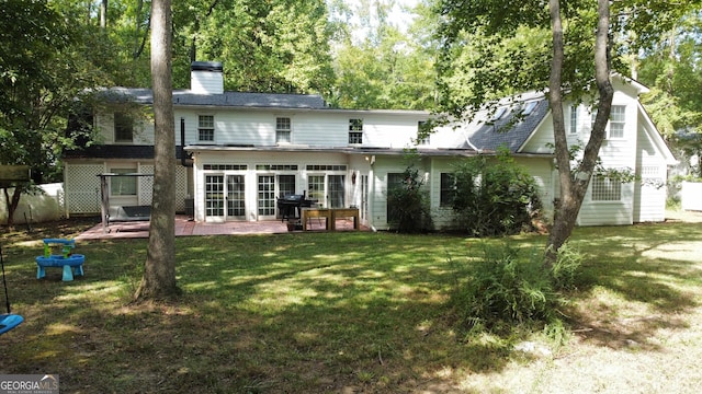 back of property featuring a patio and a yard