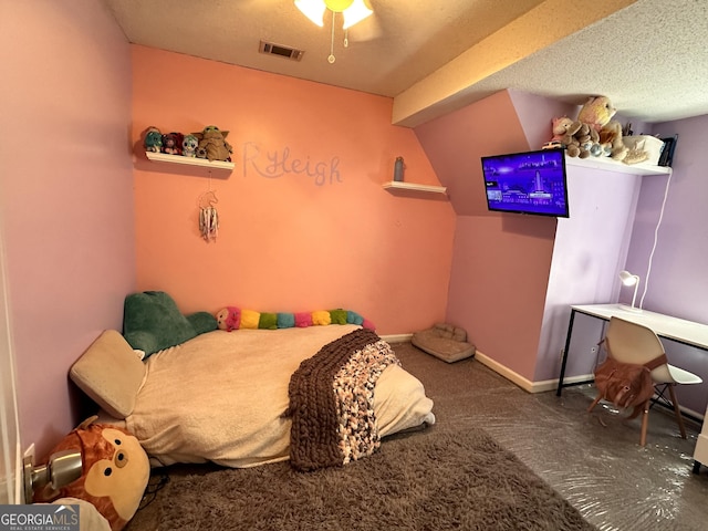 carpeted bedroom featuring a textured ceiling