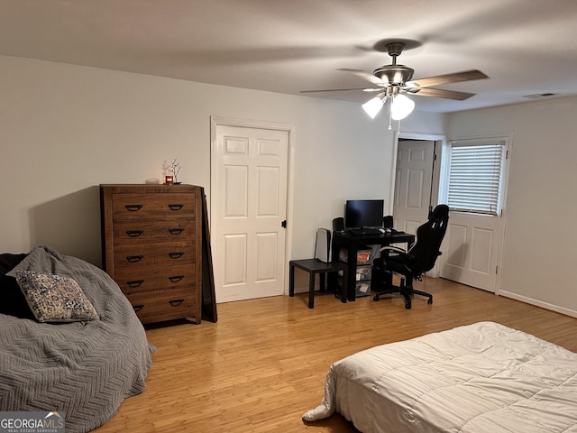 bedroom with ceiling fan and light hardwood / wood-style flooring