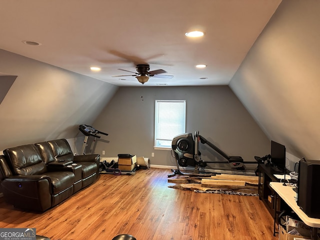 exercise area featuring hardwood / wood-style flooring, vaulted ceiling, and ceiling fan