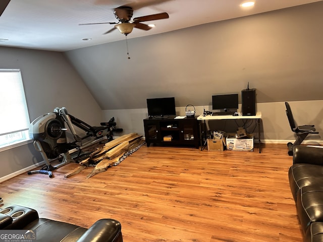 home office featuring vaulted ceiling, ceiling fan, and light hardwood / wood-style floors