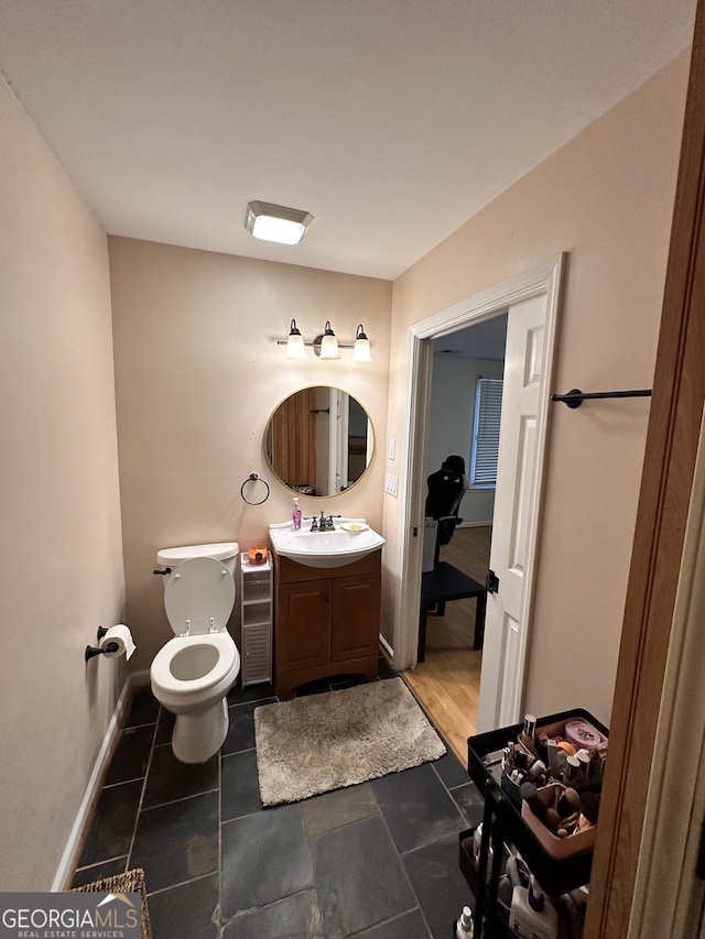 bathroom featuring vanity and toilet