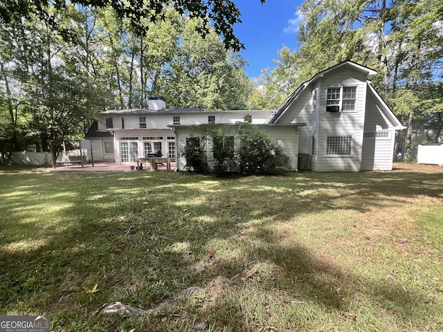 back of house featuring a patio and a yard