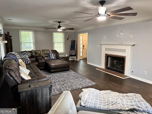 living room featuring crown molding, a tile fireplace, and dark hardwood / wood-style floors