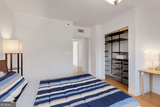 bedroom featuring light hardwood / wood-style floors and a closet