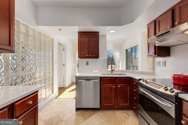 kitchen featuring tasteful backsplash, sink, light tile patterned floors, and stainless steel appliances