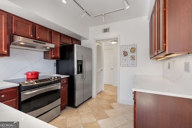 kitchen featuring appliances with stainless steel finishes, light stone countertops, and backsplash