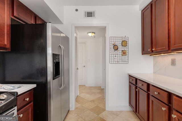 kitchen with tasteful backsplash, light stone countertops, and stainless steel appliances