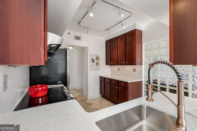 kitchen featuring tasteful backsplash, sink, and stainless steel refrigerator