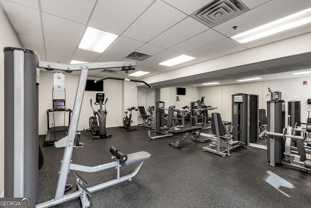 exercise room with a paneled ceiling