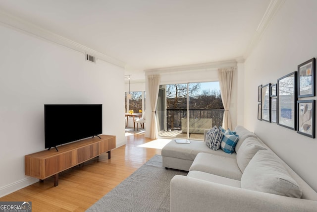 living room with ornamental molding and wood-type flooring