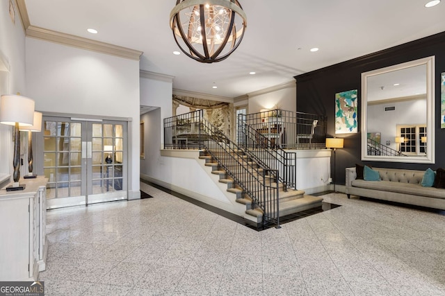 stairs featuring crown molding, a notable chandelier, and french doors