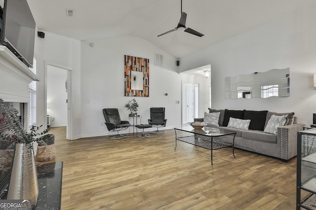 living room featuring ceiling fan, wood-type flooring, and high vaulted ceiling