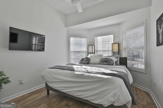 bedroom with dark wood-type flooring and ceiling fan