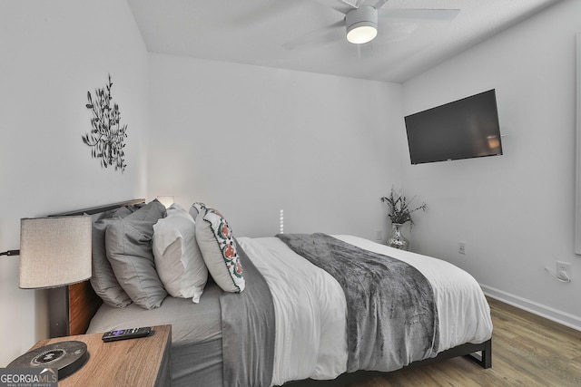 bedroom with hardwood / wood-style floors and ceiling fan