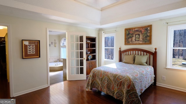 bedroom featuring dark wood-type flooring, ensuite bath, and crown molding