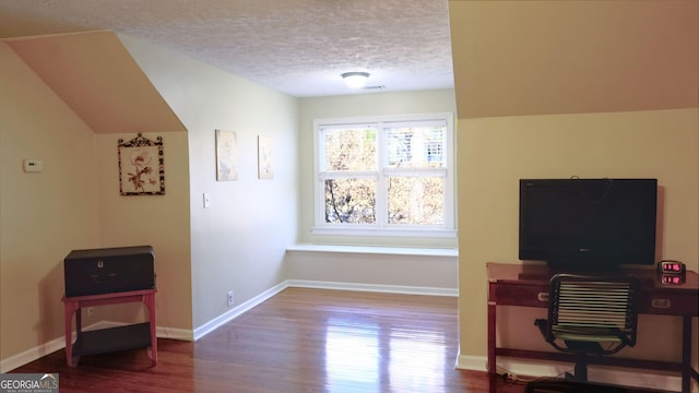 office area with hardwood / wood-style floors and a textured ceiling