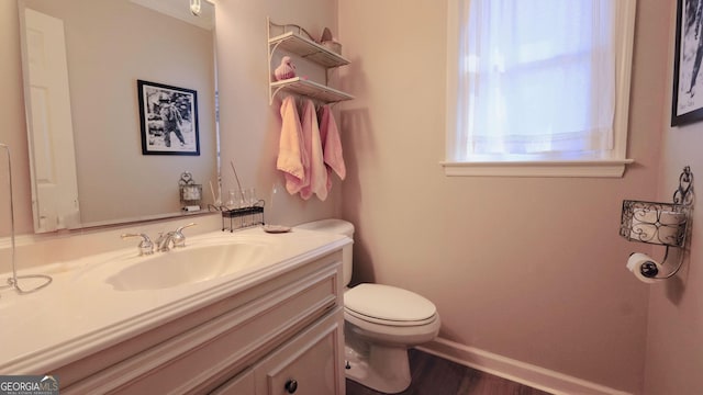 bathroom featuring hardwood / wood-style flooring, vanity, and toilet