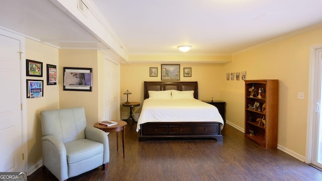 bedroom featuring crown molding and dark hardwood / wood-style flooring