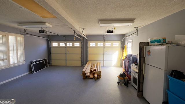 garage with white refrigerator and a garage door opener