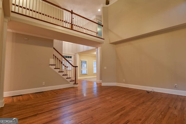 interior space featuring hardwood / wood-style flooring and a high ceiling