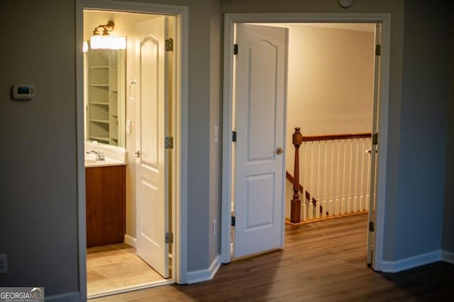 hall featuring sink and light wood-type flooring