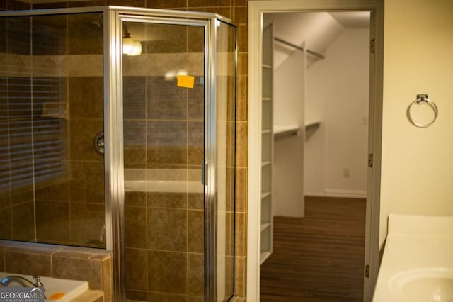 bathroom with independent shower and bath, vanity, and hardwood / wood-style flooring