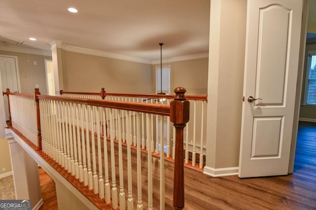 staircase featuring crown molding and hardwood / wood-style floors