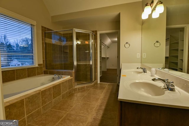 bathroom with shower with separate bathtub, lofted ceiling, tile patterned floors, and vanity