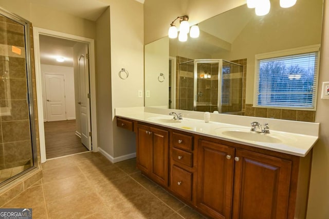 bathroom featuring tile patterned flooring, vanity, vaulted ceiling, and an enclosed shower