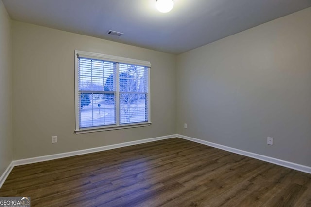 empty room featuring dark hardwood / wood-style flooring