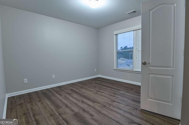 spare room featuring dark hardwood / wood-style flooring