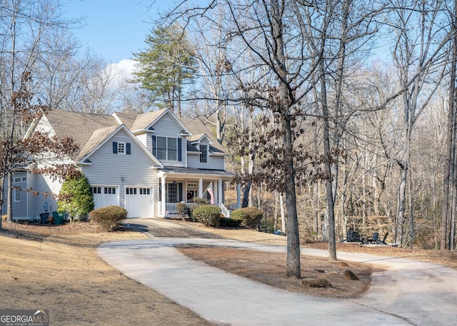 view of front of property with a garage, driveway, and a porch