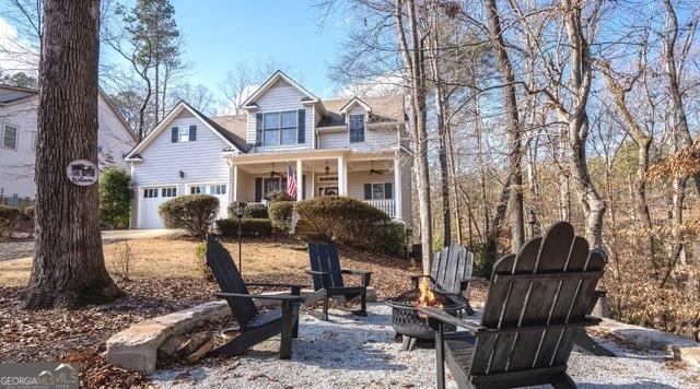 view of front of home featuring a garage and an outdoor fire pit